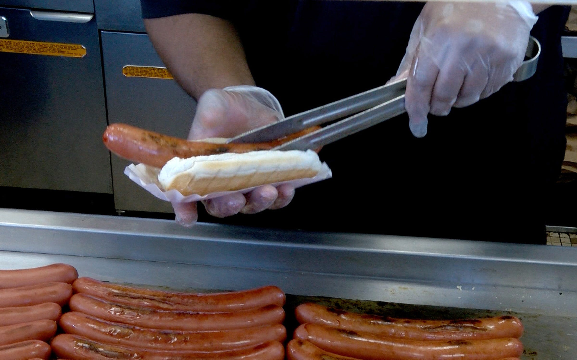 A hot dog is placed in it's bun just off the grill at the WindMill in Long Branch Friday, August 5, 2022.