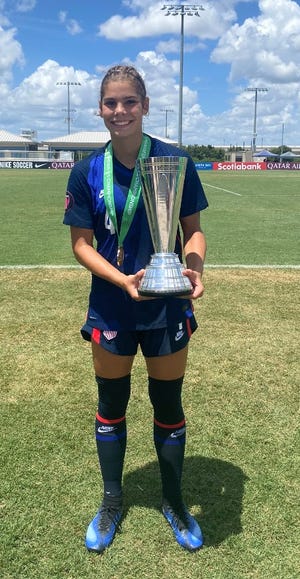 Fort Collins' Abby Ballek, the leading scorer last spring for Fossil Ridge High School's girls soccer team, poses with a trophy after helping the U.S. Youth National Team win the under-15 girls CONCACAF Cup on Sunday in Tampa, Fla. Ballek scored four goals in one game and had seven goals and five assists in the U.S. team's five games.