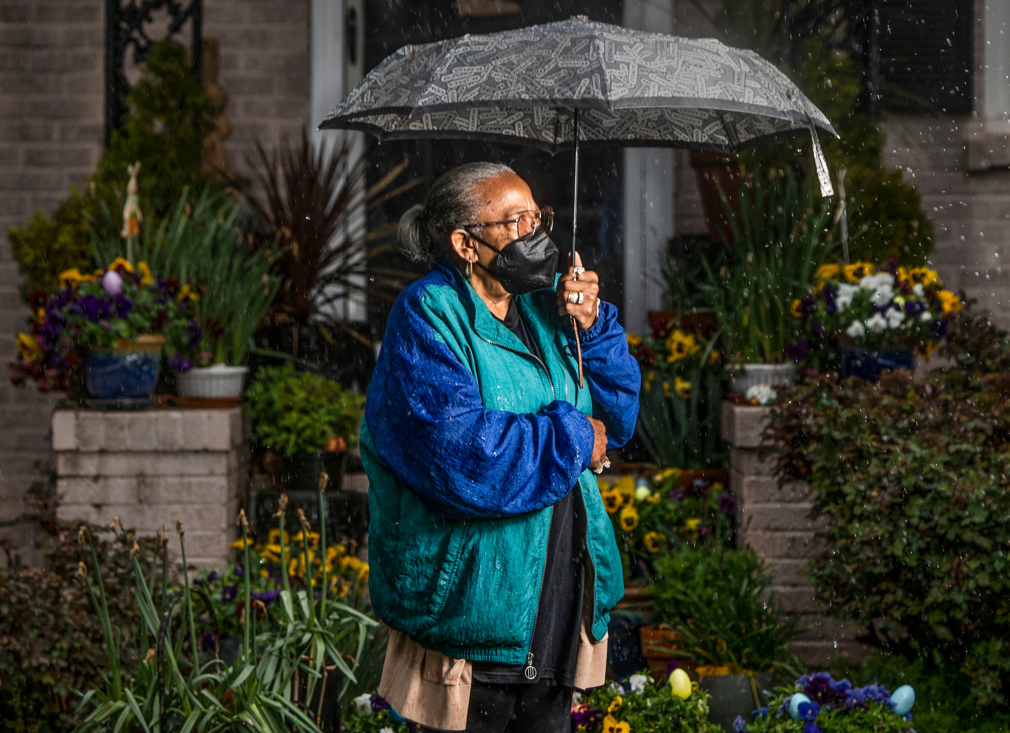 Sarah Reese poses for a portrait in the rain in front of her home in Greenville on March 23.