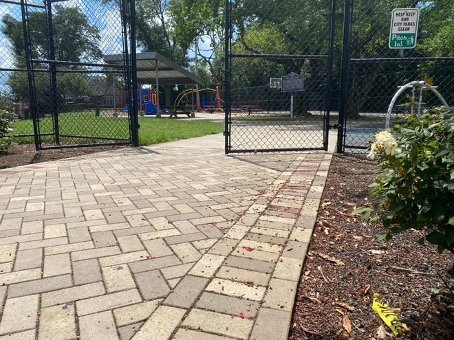 A piece of crime scene tape remained in Wilmington's One Love Park/Tatnall Playground Monday afternoon after a woman was shot Sunday night about a block away.