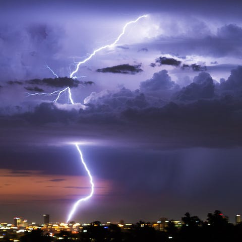 Lightning strikes as rain falls.