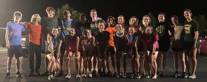 Members of the St. Mary Catholic Central cross country teams gathered for their first practice of the season at midnight Monday.