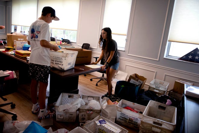 Volunteers Coley Surovek, 13, of Lake Worth Beach, and Maddie Eiland, 15, of West Palm Beach, pack and sort school supplies at the Town of Palm Beach United Way offices Tuesday. The school supplies and donations were given to Adopt-A-Family, HomeSafe and the Milagro Center.