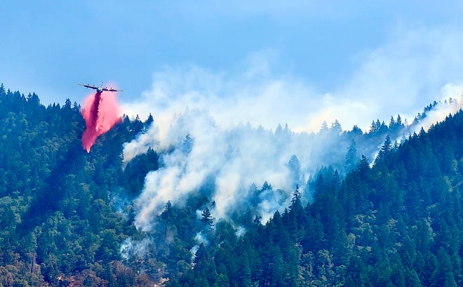 The Trinity County Sheriff's Office posted this photo Monday, Aug. 8, 2022, on Facebook of an air tanker dropping retardant during the Six Rivers Lightning Complex.