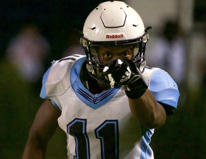 Gadsden County running back Johntarrious Thomas points to the camera after scoring a touchdown in a game against Rickards on Sept. 10, 2021, at Gene Cox Stadium.
