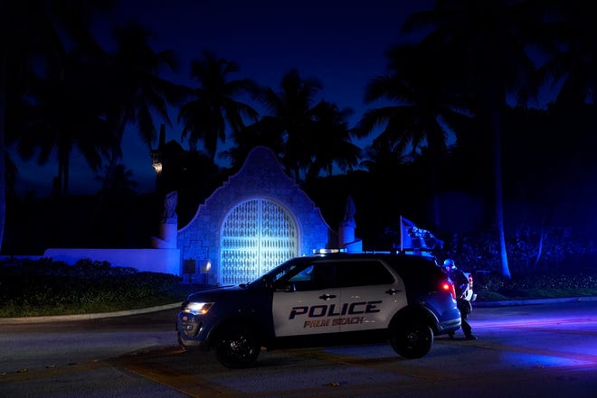 FILE - Police stand outside the entrance to former President Donald Trump's Mar-a-Lago estate, Monday, August 8, 2022, in Palm Beach, Fla.  The FBI's search of Trump's Mar-a-Lago estate marks a dramatic and unprecedented escalation in the former president's law enforcement surveillance, but Florida operations only as part of an investigation into Trump and his time in office.  (AP Photo / Wilfredo Lee, File) ORG XMIT: WX402
