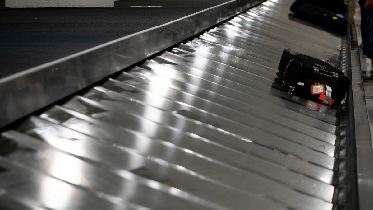 In this June 2, 2021, photo luggage is seen on a conveyer belt at Phoenix Sky Harbor International Airport. (AP Photo/Jenny Kane)