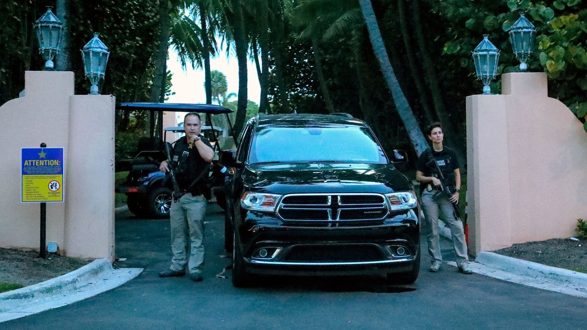 Secret service agents stand at the gate of Mar-a-Lago after the FBI issued warrants at August 8, 2022 in Palm Beach, Fla.