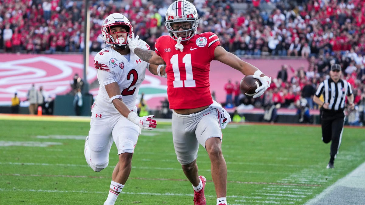 Ohio State wide receiver Jaxon Smith-Njigba fends off Utah cornerback Micah Bernard as he races to the end zone for a touchdown during the second quarter of the 2022 Rose Bowl in Pasadena, Calif.