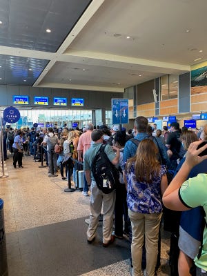 People pack the security lines at the Austin Airport on Aug. 10 after the terminal was evacuated for a fire alarm. Every passenger who was in the building has to be rescreened by TSA.