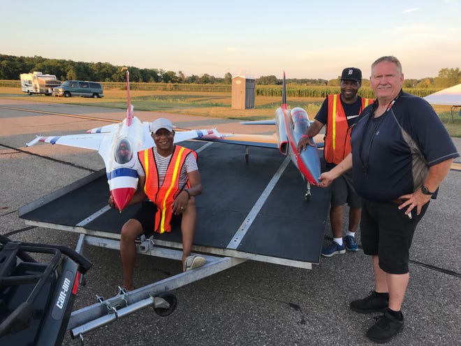 Cleveland Johnson of Florida (left), Curtis Wade (background) and Keith Yates of Kentucky pose with two model jet airplanes at a recent show at Monroe's Custer Airport.