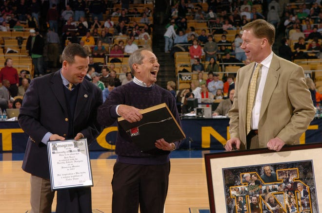 Former Notre Dame play-by-play voice Jack Lorri, center, spent 38 seasons calling Irish games on the radio. Here, he's presented with an honorary Monogram Club membership.