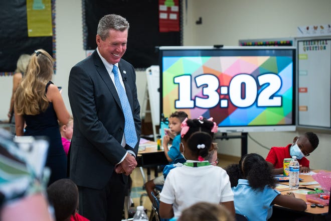 Palm Beach County School Superintendent Mike Burke speaks to a 5th grade student at Hidden Oaks Elementary School in Lake Worth during the first day of school in August.