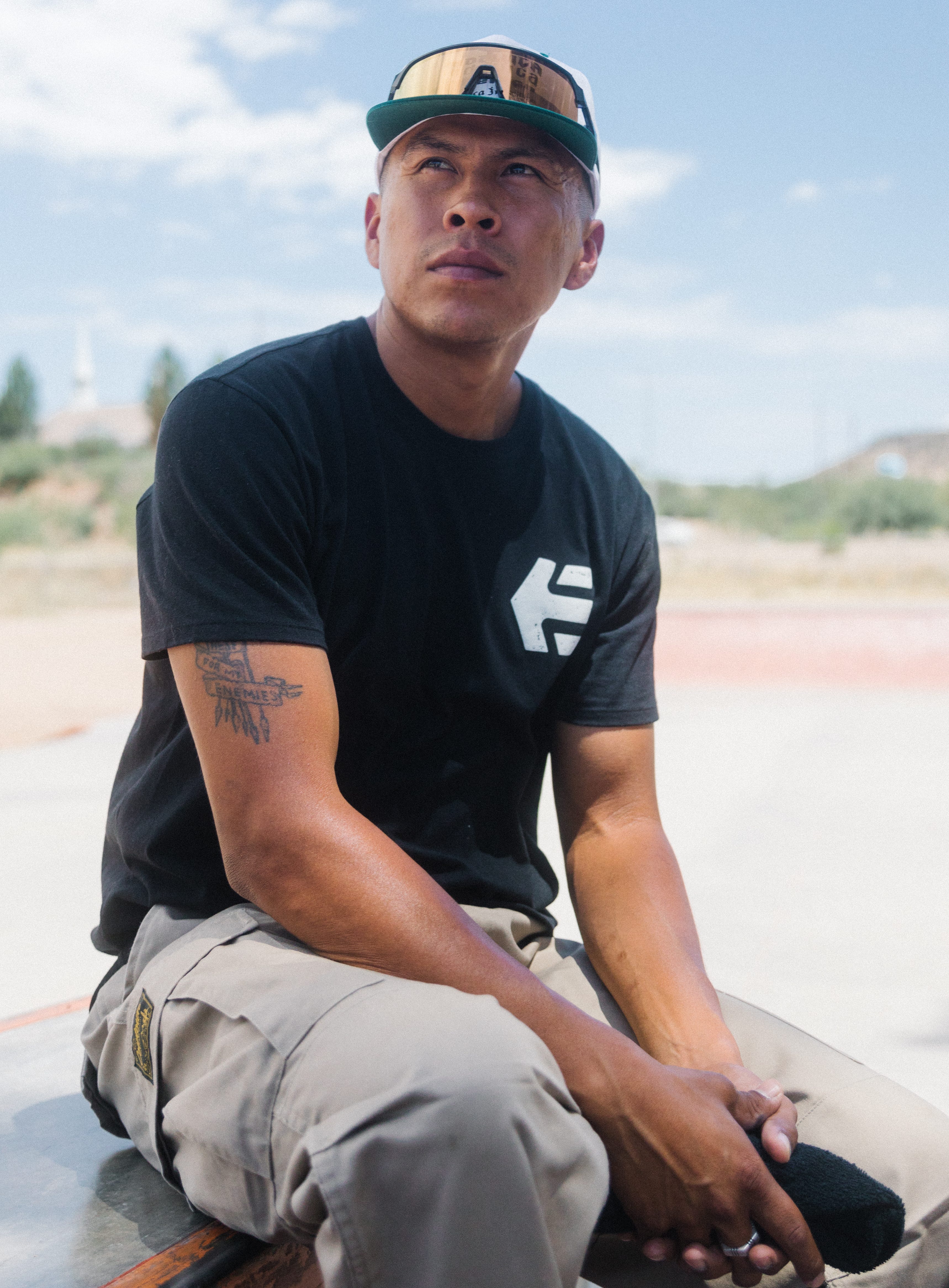 Douglas Miles Jr. watches young skaters at the new San Carlos Apache skate park on the San Carlos Reservation east of Globe on July 13, 2022.