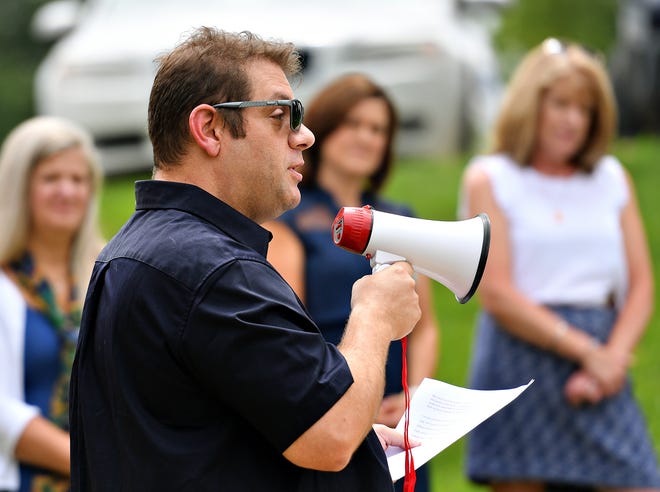Chris Rodkey, who is pastor of St. Paul's United Church of Christ in Dallastown, and is running for state representative in the 93rd district, speaks during a rally of more than 150 teachers and community members outside Dallastown Area High School in York Township, Wednesday, Aug. 10, 2022. The rally was held just before the Dallastown Area School District School Board would return to contract negotiations with the Dallastown Area Education Association. Three of Rodkey’s four children attend school in the district. Dawn J. Sagert photo