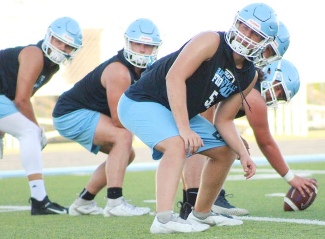 Brody Shuman, foreground, and other linemen get set for a play during Bartlesville High football practice on Aug. 10, 2022.