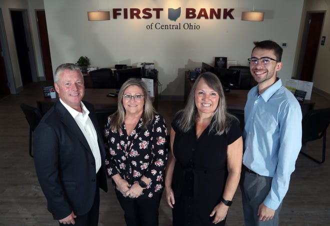 From left, First Bank of Central Ohio's John Smiley, chairman and CEO; Donna Chambers, vice president; Beth Maisenbacher, senior vice president; and Matt Johnson, relationship banker, are shown inside the bank's new Upper Arlington location following an Aug. 11 ribbon-cutting ceremony. This is the second branch for the Worthington-based bank.