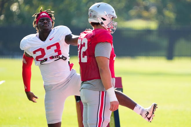 Aug 11, 2022; Columbus, OH, USA;  Ohio State Buckeyes defensive end Omari Abor (23) stretches with offensive lineman Avery Henry (72) during football camp at the Woody Hayes Athletic Center. Mandatory Credit: Adam Cairns-The Columbus Dispatch