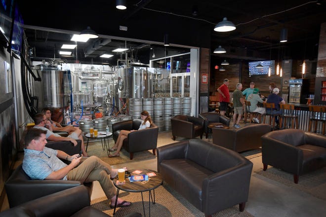 Customers relax inside the family-owned 2nd Bay Brewing Company at 108 Bartram Oaks Walk, Suite 101 in Fruit Cove.  The family-owned microbrewery has eight of its own unique, craft beers on tap with plans to expand to 12.