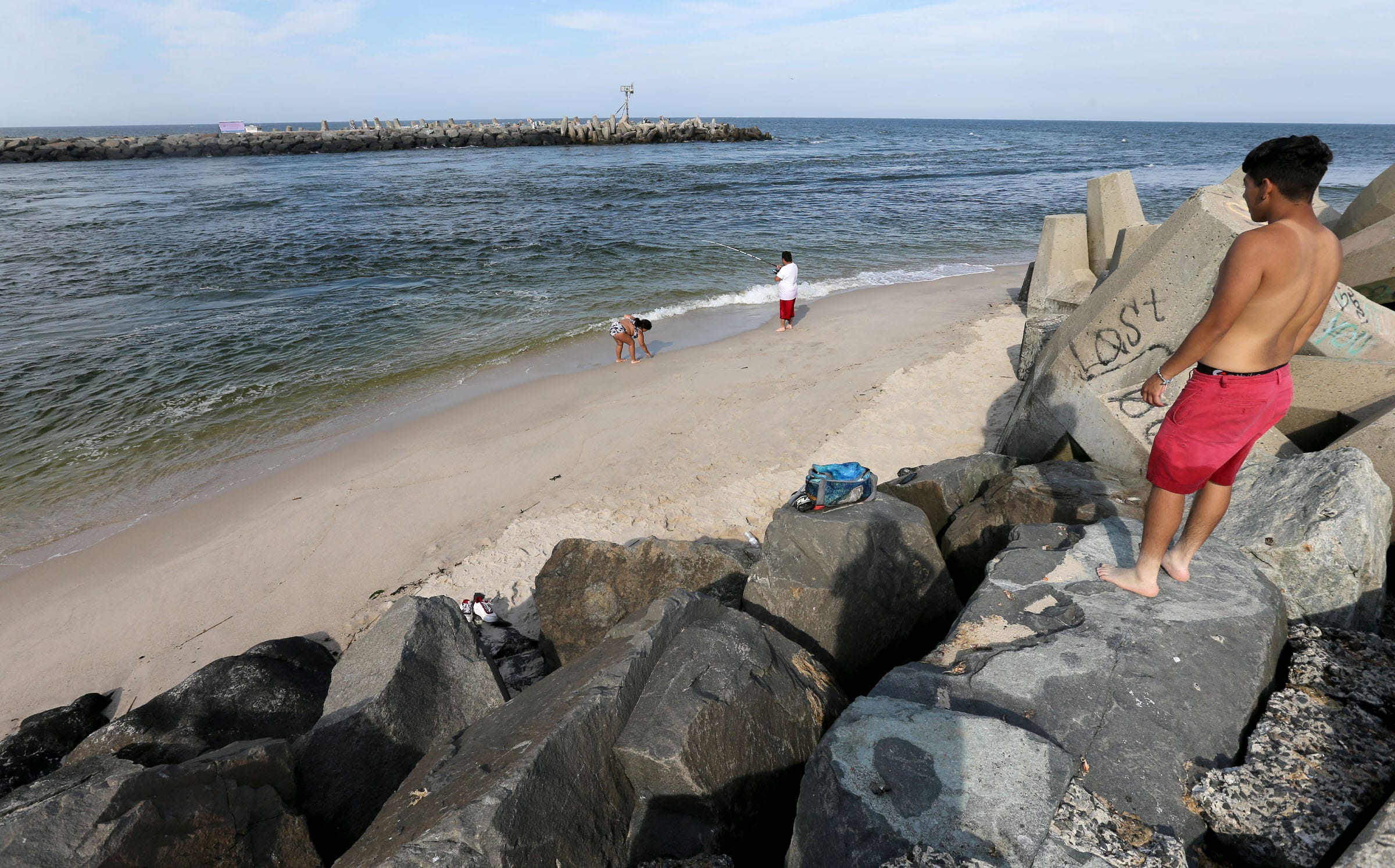 People fish from the shoal on the Point Pleasant Beach side of the Manasquan Inlet Thursday afternoon, August 11, 2022. This is about four hours after high tide.