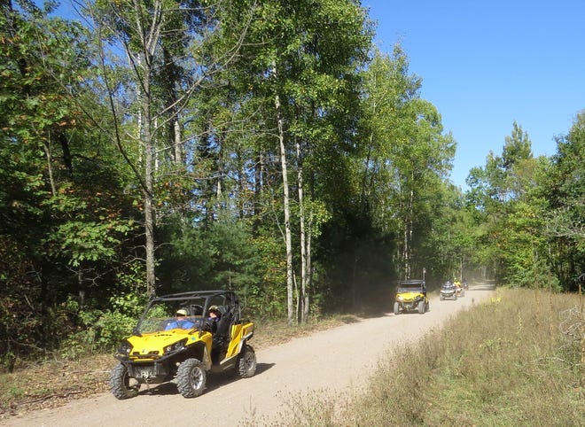 Members of the Hidden Bear ATV Club participate in a trail ride in 2017.