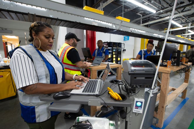 Amazon employees work in the stow and picking area at the Amazon Robotic Sorting Fulfillment Center in Canton Miss., Thursday, Aug. 11, 2022. The million, square-foot-facility is the first Amazon robotics sort center in the state.