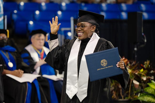 Middle Tennessee State University College of Behavioral and Health Sciences graduate Maryrose Uwimana holds her degree with excitement after crossing the stage at Murphy Center Aug. 6, at the university's summer commencement ceremony. MTSU presented 857 degrees to undergrad and graduate students during the event, which concludes the university's 111th academic year.