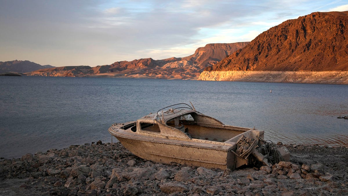 A formerly sunken boat sits high and dry along the shoreline of Lake Mead at the Lake Mead National Recreation Area, on May 10, 2022, near Boulder City, Nev. Another body has surfaced at Lake Mead, this time in a swimming area where water levels have dropped as the Colorado River reservoir behind Hoover Dam recedes due to drought and climate change.