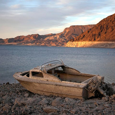 A formerly sunken boat sits high and dry along the