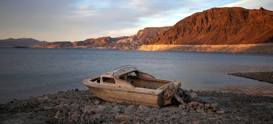 A formerly sunken boat sits high and dry along the shoreline of Lake Mead at the Lake Mead National Recreation Area, on May 10, 2022, near Boulder City, Nev. Another body has surfaced at Lake Mead, this time in a swimming area where water levels have dropped as the Colorado River reservoir behind Hoover Dam recedes due to drought and climate change.