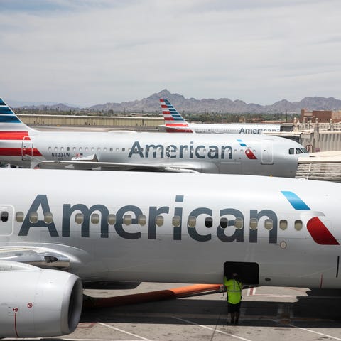 FILE -   American Airlines aircraft wait at gates 