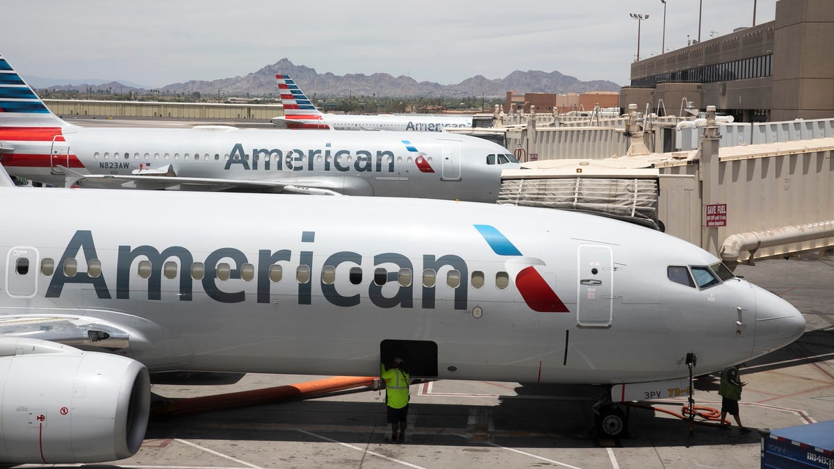 FILE -   American Airlines aircraft wait at gates at Phoenix Sky Harbor International Airport in Phoenix, on June 7, 2021. (AP Photo/Jenny Kane)
