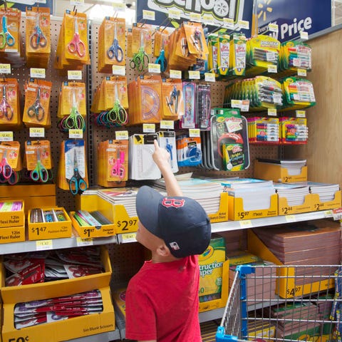 A child chooses school supplies at Walmart.