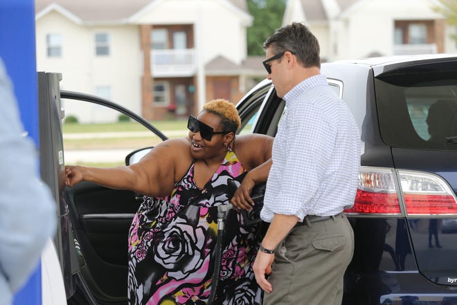 A motorist and Indiana Senator Todd Young were shocked by how much it costs to fill up her vehicle at the Marathon gas station on 96 Twyckenham, in Lafayette, on Friday, Aug. 12, 2022. The sign says, "$2.38 gas line starts here."