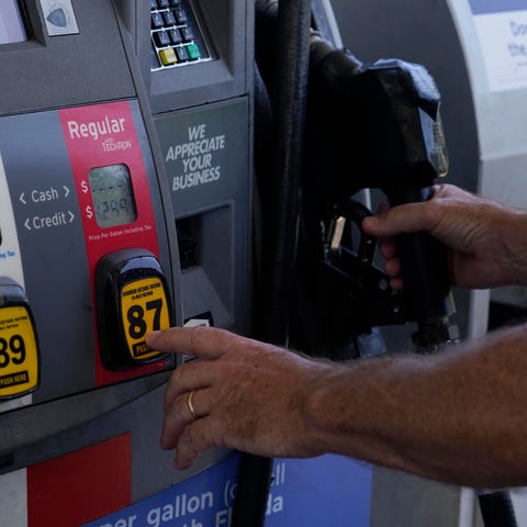 A customer pumps gas at an Exxon gas station, Tues