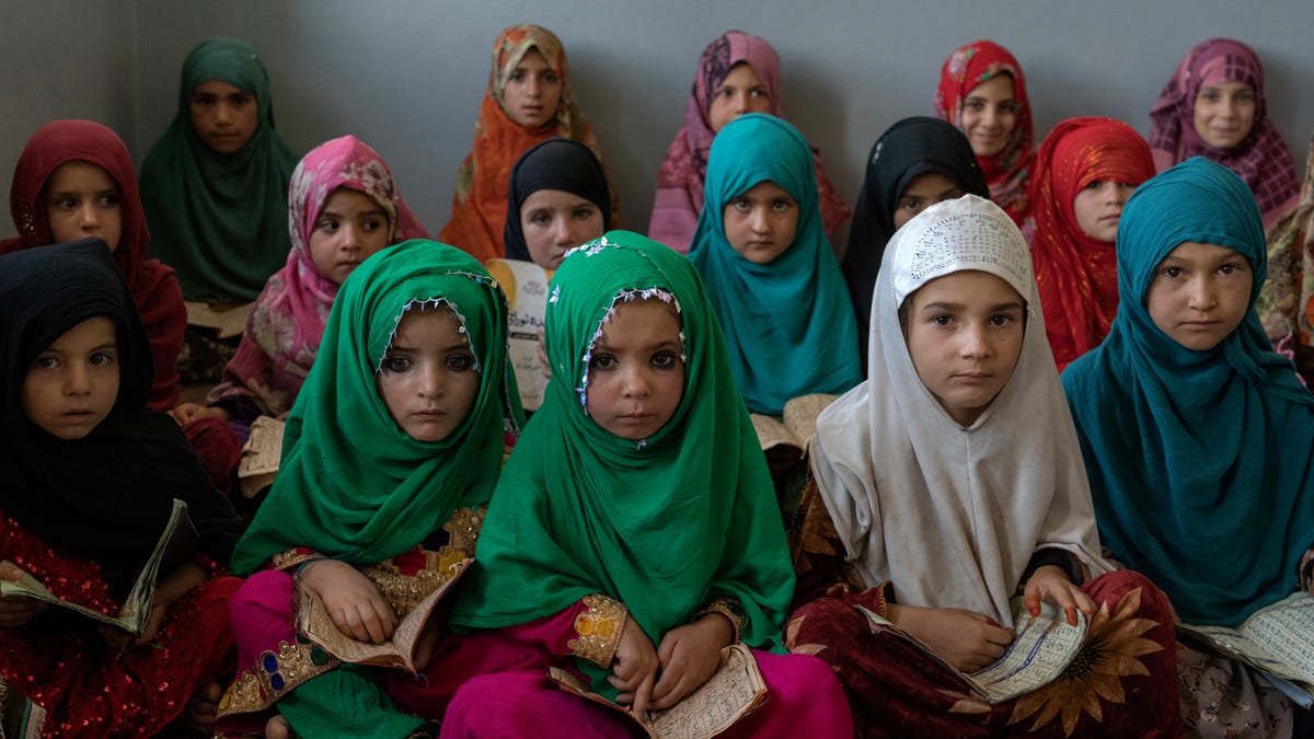 Afghan girls read the Quran in the Noor Mosque outside the city of Kabul, Afghanistan, Wednesday, Aug 3, 2022. Maulvi Bakhtullah, the head of the mosque, said that the number of girls who come to this mosque to learn Quran has multiplied after the closure of public schools. For most teenage girls in Afghanistan, it's been a year since they set foot in a classroom. With no sign the ruling Taliban will allow them back to school, some   girls and parents are trying to find ways to keep education from stalling for a generation of young women. (AP Photo/Ebrahim Noroozi) ORG XMIT: DV516