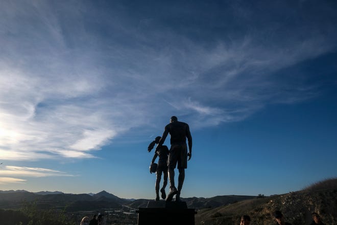 A bronze sculpture featuring Kobe Bryant and his daughter Gianna Bryant is displayed at the site of a 2020 helicopter crash in Calabasas, California.