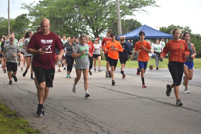 Participants run Saturday, Aug. 13, 2022, in the “Your Mind Matters” 3.2 miles for mental health run/walk event, which began at the Addison Fire Station and traversed throughout the Addison village community. More than 250 people participated in the run.