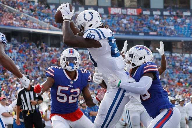 Indianapolis Colts tight end Jelani Woods (80), center, scores after receiving a touchdown pass as Buffalo Bills linebacker Marquel Lee (52) and safety Josh Thomas, right, try to defend in the second half of a preseason NFL football game, Saturday, Aug. 13, 2022, in Orchard Park, N.Y. (AP Photo/Jeffrey T. Barnes)