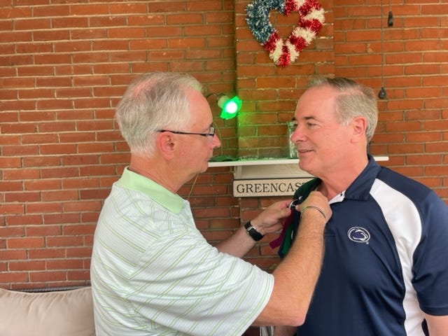 Greencastle Mayor Ben Thomas Jr. pins an Old Home Week badge on U.S. Congressman John Joyce, making him an honorary citizen of Greencastle.