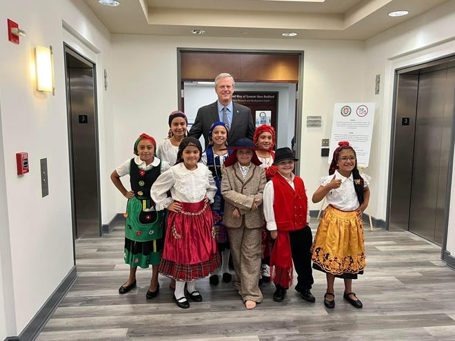 Gov. Charlie Baker poses for a photo with members of Discovery Language Academy's Folklore Group during a special visit he paid to the New Bedford Portuguese school on Aug. 10.