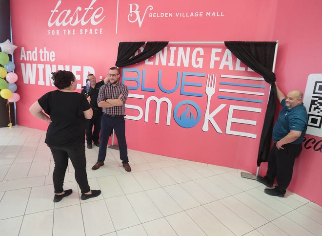 Nikolina "The Mid Day Diva" Q92 radio host interviews Blue Smoke owner/chef Jamie Moore in the Belden Village Mall food court Monday. Blue Smoke won the Taste for the Space contest held by the mall.