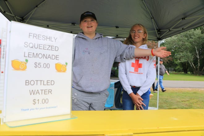 Emily Young and her best friend, Bailee Glynn, sell lemonade Aug. 14 at the farmers market in Kronenwetter.