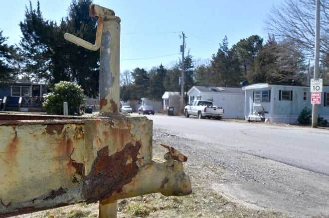 A rusted trailer hitch on an abandoned trailer frame at the entrance to a mobile home park in Pocasset, 2020.