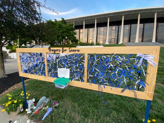 Ribbons are tied to a prayer board for Officer Seara Burton outside the Richmond Municipal Building.