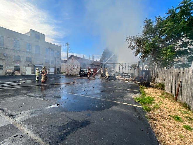 Firefighters battle a fire on August 15, 2022 in Sheboygan, Wis.