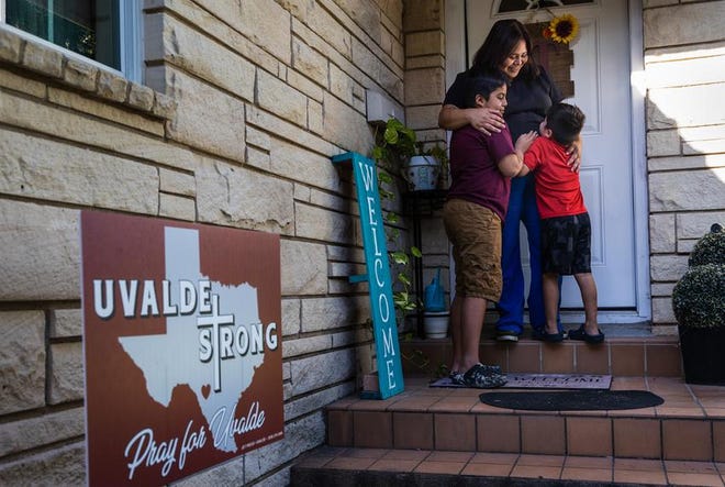 Brianna Gonzales and her two sons, Javier, 10, and Emilio, 5, in front of their home in Uvalde on Aug. 10, 2022. After careful deliberation, Gonzales decided to send both of her sons back to in-person classes for the upcoming school year.