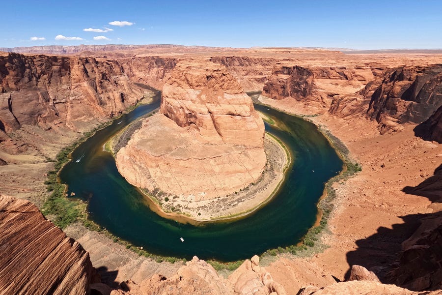 The Colorado River flows at Horseshoe Bend in the Glen Canyon National Recreation Area, Wednesday, June 8, 2022, in Page, Arizona. The U.S. Bureau of Reclamation is expected to publish hydrology projections on Tuesday that will trigger agreed-upon cuts to states that rely on the river.