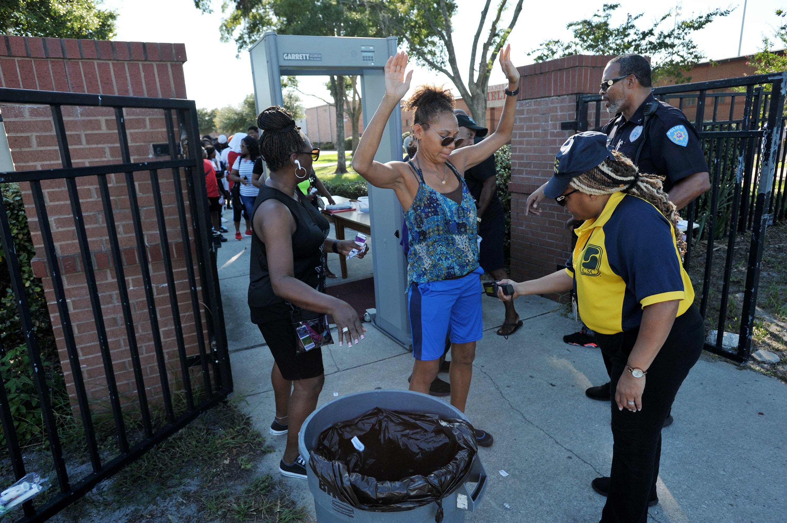 Security check fans as they enter the football field ahead of Friday evening's game at Raines High School. The Raines Vikings hosted Orlando's Jones High School Fightin' Tigers at Raines High School Friday, August 23, 2019 where the back-to-back two time state championship Vikings fell 40 to 15 in their season opener. [Bob Self/Florida Times-Union]
