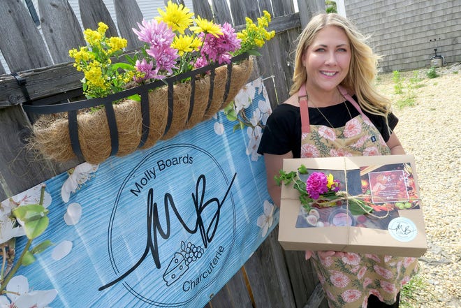 Molly Boards owner Molly Kastner has a boxed charcuterie board ready for delivery outside her office in Point Pleasant Beach on Wednesday, August 17, 2022.